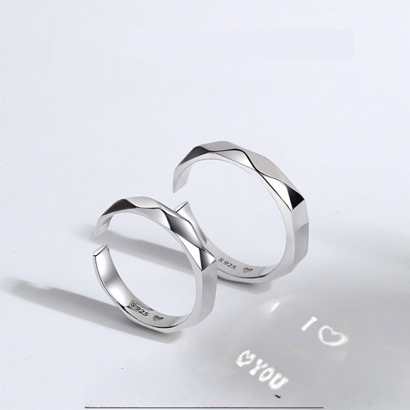 A close-up image of two Jingqian S925 Sterling Silver Light Reflection Rings with faceted surfaces, arranged in a mirrored fashion. A shadow below them displays the text "I â™¡ YOU" with a heart symbol between "I" and "YOU", creating a romantic impression enhanced by the light reflection from the rings.