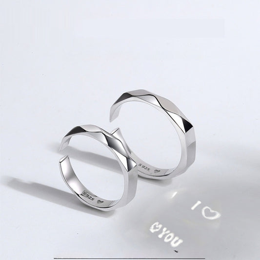 A close-up image of two Jingqian S925 Sterling Silver Light Reflection Rings with faceted surfaces, arranged in a mirrored fashion. A shadow below them displays the text "I â™¡ YOU" with a heart symbol between "I" and "YOU", creating a romantic impression enhanced by the light reflection from the rings.